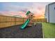 Fenced backyard with playset featuring a slide, swing, climbing deck and mulch at 701 Squire Pope Rd, Summerville, SC 29486