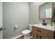 Stylish half bathroom featuring modern fixtures and a wood-framed mirror at 701 Squire Pope Rd, Summerville, SC 29486