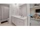 Well-lit bathroom featuring a white vanity with sink, a large mirror, and a shower with a striped curtain at 701 Squire Pope Rd, Summerville, SC 29486