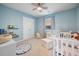 Cozy bedroom with a crib, changing table, and light blue walls and accent furniture at 701 Squire Pope Rd, Summerville, SC 29486