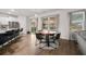 Open-concept kitchen/dining area with modern appliances, round dining table, and view of the backyard at 701 Squire Pope Rd, Summerville, SC 29486