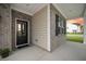 Inviting front porch with brick accents, white columns, and a stylish front door at 701 Squire Pope Rd, Summerville, SC 29486