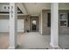 Inviting front porch with brick accents, white columns, and a stylish front door at 701 Squire Pope Rd, Summerville, SC 29486