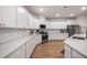 Well-lit kitchen with stainless steel appliances, white cabinetry, subway tile backsplash, and hardwood floors at 701 Squire Pope Rd, Summerville, SC 29486