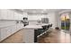 Modern kitchen with white cabinets, stainless steel appliances, kitchen island, and access to the backyard at 701 Squire Pope Rd, Summerville, SC 29486