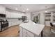 Bright kitchen features an island with seating, stainless appliances, and sliding glass doors to the backyard at 701 Squire Pope Rd, Summerville, SC 29486