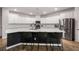Modern kitchen with stainless steel appliances, an island with bar seating, and bright white cabinetry at 701 Squire Pope Rd, Summerville, SC 29486