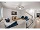 Bright living room with hardwood floors, a ceiling fan, and an expansive sectional sofa at 701 Squire Pope Rd, Summerville, SC 29486