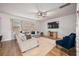 Sunlit living room featuring a cozy sectional sofa, TV, and stylish decor at 701 Squire Pope Rd, Summerville, SC 29486