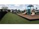 Community playground featuring multiple slides and play structures, surrounded by green lawn at 701 Squire Pope Rd, Summerville, SC 29486