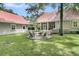 Charming backyard with fire pit, ample seating, green space and screened-in porch for outdoor entertaining at 7021 Schooner St, Charleston, SC 29492