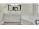 Bright bathroom featuring double vanity and large soaking tub at 7021 Schooner St, Charleston, SC 29492