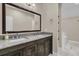 Bathroom featuring double sinks with a granite countertop and ample storage in dark wooden cabinetry at 7021 Schooner St, Charleston, SC 29492