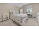 Comfortable bedroom featuring a cozy bed with stylish linens, bedside table, and a sleek workstation at 7021 Schooner St, Charleston, SC 29492