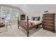 Warm bedroom boasting a wooden bed frame, matching dresser, and ample natural light from a large window at 7021 Schooner St, Charleston, SC 29492