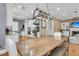 Open dining area with hardwood floors, kitchen views, and rustic chandelier at 7021 Schooner St, Charleston, SC 29492