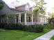Charming two-story home with a welcoming front porch, red roof, and lush green lawn at 7021 Schooner St, Charleston, SC 29492