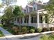 Charming two-story home with a inviting front porch, landscaped yard, and red roof at 7021 Schooner St, Charleston, SC 29492