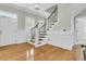 Foyer with hardwood floors and staircase featuring wood and wrought iron at 7021 Schooner St, Charleston, SC 29492