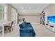 Cozy living room featuring a blue sofa, built-in bookshelves, and a bright workspace with natural light at 7021 Schooner St, Charleston, SC 29492
