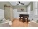 Living room with hardwood floors, piano, and plantation shutters at 7021 Schooner St, Charleston, SC 29492