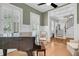 Living room featuring a piano, hardwood floors, and plantation shutters at 7021 Schooner St, Charleston, SC 29492