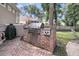 Outdoor kitchen area features a stainless steel built-in grill on brick base and black countertops at 7021 Schooner St, Charleston, SC 29492