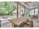 Bright screened porch with a large table and chairs, perfect for outdoor dining and relaxation at 7021 Schooner St, Charleston, SC 29492