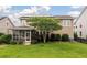 View of backyard featuring a screened in porch, green grass and tree at 705 Quintan St, Summerville, SC 29486