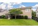 Backyard view featuring the screened in porch, green grass, beautiful tree, and siding of the house at 705 Quintan St, Summerville, SC 29486