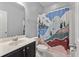 Functional bathroom featuring a decorative shower curtain, vanity with sink, and toilet at 705 Quintan St, Summerville, SC 29486