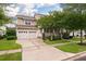 Beautiful home with a two-car garage, well-manicured lawn, and covered front porch framed by mature trees at 705 Quintan St, Summerville, SC 29486