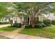 Inviting home exterior featuring a well-maintained front yard, walkway, and covered porch framed by trees at 705 Quintan St, Summerville, SC 29486
