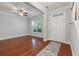 Inviting living room featuring wood flooring, large windows, and a view of the staircase at 705 Quintan St, Summerville, SC 29486