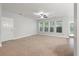 Bright, open living room with neutral tones, large windows, and ceiling fan at 705 Quintan St, Summerville, SC 29486