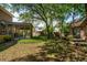 Large backyard features a playhouse, covered patio and shade trees at 712 Wakendaw Blvd, Mount Pleasant, SC 29464