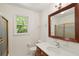 Bright bathroom features a framed mirror, vanity, and glass enclosed shower at 712 Wakendaw Blvd, Mount Pleasant, SC 29464