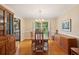 Elegant dining room with hardwood floors, a chandelier, and large windows overlooking the yard at 712 Wakendaw Blvd, Mount Pleasant, SC 29464
