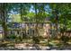 Traditional two-story brick home featuring blue shutters, mature trees, and well-maintained landscaping at 712 Wakendaw Blvd, Mount Pleasant, SC 29464