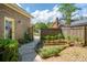 Landscaped backyard with a raised garden bed and brick paver walkway at 712 Wakendaw Blvd, Mount Pleasant, SC 29464