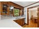 Updated kitchen featuring quartz counters, a stainless dishwasher, and wood cabinets at 712 Wakendaw Blvd, Mount Pleasant, SC 29464