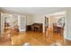 Bright and open living room with hardwood floors, a piano, and easy access to other living areas at 712 Wakendaw Blvd, Mount Pleasant, SC 29464