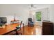 Bright home office features hardwood floors, large windows with a ceiling fan for a comfortable workspace at 712 Wakendaw Blvd, Mount Pleasant, SC 29464
