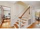 Bright foyer showcasing a hardwood staircase with white risers and beautiful wood floors at 712 Wakendaw Blvd, Mount Pleasant, SC 29464