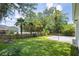 Wide shot of large backyard with tall trees, in-ground pool and wooden perimeter fence at 7511 Hawks Cir, Hanahan, SC 29410