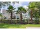 Backyard with tall palm trees, grass and a wooden fence separating the property lines at 7511 Hawks Cir, Hanahan, SC 29410