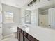 Bright bathroom featuring a large mirror, modern vanity, and combined shower and tub at 7511 Hawks Cir, Hanahan, SC 29410