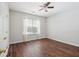 Spacious bedroom features modern hardwood flooring, a ceiling fan, and a window at 7511 Hawks Cir, Hanahan, SC 29410