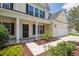 Inviting two-story home with a charming front porch, attached garage, walkway and lush landscaping at 7511 Hawks Cir, Hanahan, SC 29410