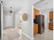 Hallway leads to a kitchen featuring wooden cabinetry and stainless steel appliances at 7511 Hawks Cir, Hanahan, SC 29410